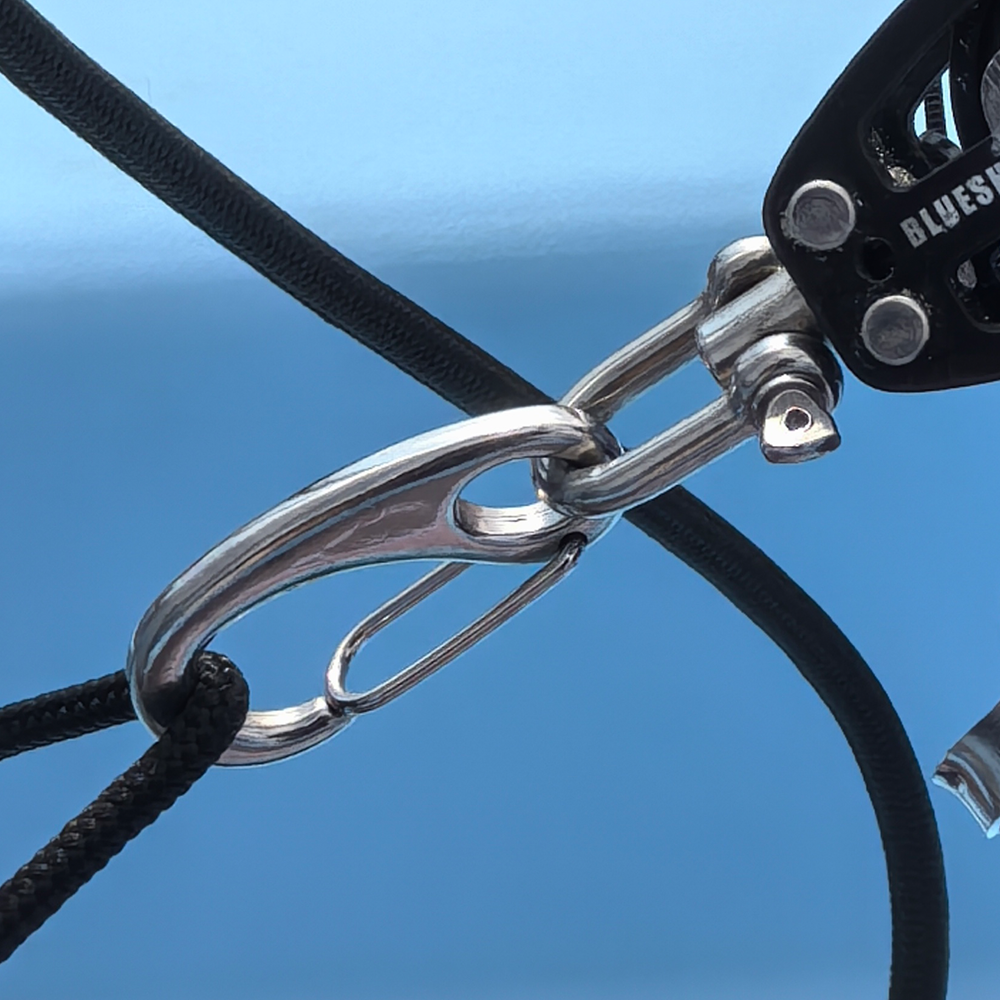 Stainless steel snap hook attached to marine rigging